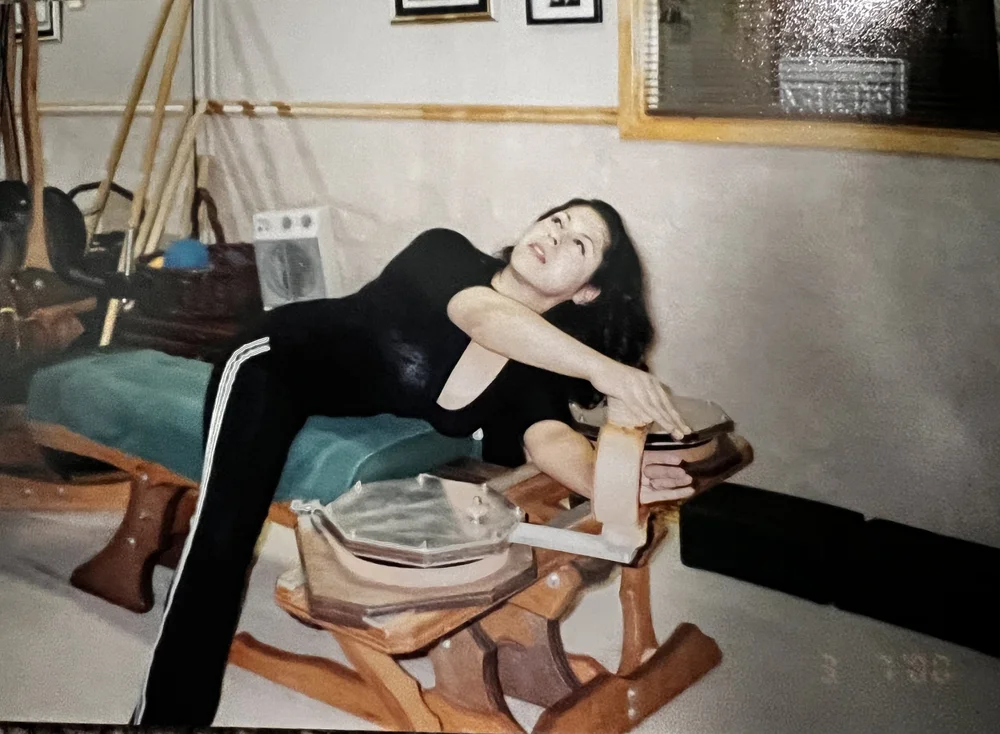 Sonia Lopez arching over the GYROTONIC handle unit in the early days of the studio