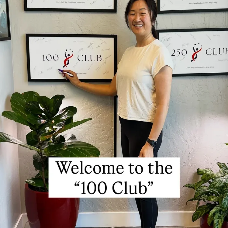 Students celebrating their 100 Club milestone for a hundred hours of Pilates and GYROTONIC training